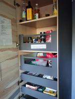 a kitchen pantry with a door open with foodagentsagentsagentsagents at VILLA KB&#39;HOME in Le Touquet-Paris-Plage