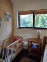 a nursery with a crib and a window at VILLA KB&#39;HOME in Le Touquet-Paris-Plage