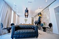 a living room with a blue couch and a brick wall at Jupiter Heritage Hotel in Split
