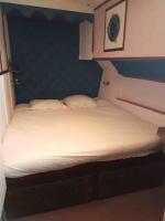 a bed with two pillows on it in a room at PÉNICHE authentique tout confort in Aigues-Mortes