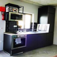 a kitchen with a purple stove and a microwave at Cabin 4 Savynomad Harbour Residences wow Views in Cospicua