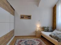 a bedroom with white walls and a bed and a rug at Altstadtparee in Steyr