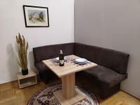 a couch with a table and a bottle of wine at Altstadtparee in Steyr