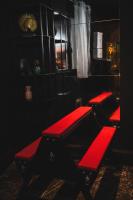 two red benches in a dark room with a window at Amour d&#39;une Nuit, LoveRoom in Sarcelles