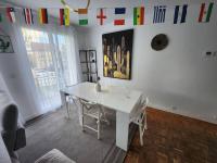 a white table and chairs in a room with flags at Maison proche Paris JO 2024 in Franconville