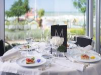 a table with plates of food and glasses on it at Hotel Michelangelo in Riccione