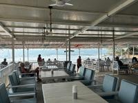 a restaurant with tables and chairs on the beach at S2 Beach Cottages in Morjim