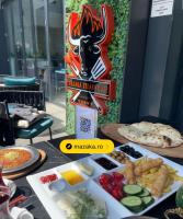 een tafel met borden en een bord bij 365 Apartments in Bucharest in Boekarest