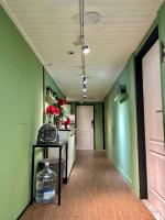 an empty hallway with green walls and a white door at Taipei Triple Tiger Inn in Taipei
