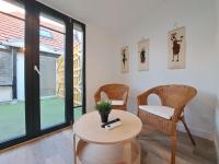 a living room with a table and chairs and a window at Maputo - Appartement climatisé in Reims