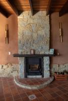 a stone fireplace in a room with a brick wall at Eco Lodge de Construção Natural com Vista Panorâmica in Nova Friburgo