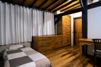 a bedroom with a bed and a desk in a room at Eco Lodge de Construção Natural com Vista Panorâmica in Nova Friburgo