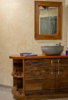 a bathroom with a sink and a mirror on a counter at Eco Lodge de Construção Natural com Vista Panorâmica in Nova Friburgo