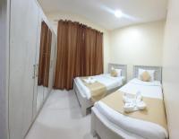 Postel nebo postele na pokoji v ubytování Al Khaleej Plaza Furnished Apartments LLC