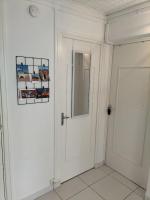 a white door in a room with a mirror at Joli appartement proche métro in Lyon