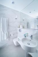 a white bathroom with a sink and a toilet at FINESTATE Coliving Champs-Elysées in Paris