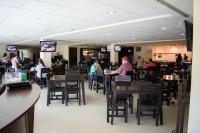 a dining room with people sitting at tables in a restaurant at Los Herederos Hotel Piedras Negras in Piedras Negras