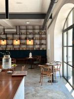 a dining room with tables and chairs and shelves at Resort po.spolu in Mokrovraty