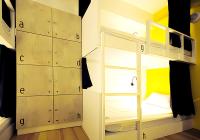 a room with two bunk beds and a room with yellow walls at We Come Hostel in Taipei