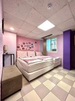 a bedroom with a large bed and a purple wall at Taipei Triple Tiger Inn in Taipei