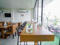 a book on a table in a restaurant with chairs at Saltstayz Select - Unitech Cyber Park & Sector 39 in Gurgaon