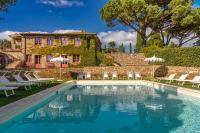 una piscina frente a una casa con sillas y un edificio en Le Ragnaie, en Montalcino