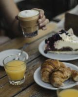 a table with two plates of desserts and two glasses of coffee at Hotel Plaza in Colón
