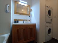 a bathroom with a sink and a washing machine at résidence la clairière aux portes de la baie de Somme in Abbeville