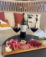 a plate of meat and cheese and two glasses of wine at Hôtel Restaurant BO &amp; MIA in La Baule