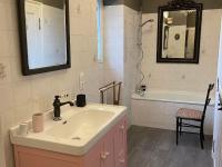 a bathroom with a sink and a tub and a mirror at Gîte Bazouges-sur-le-Loir, 6 pièces, 10 personnes - FR-1-410-377 in Bazouges-sur-le-Loir