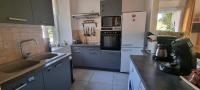 a kitchen with blue cabinets and a white refrigerator at Meublé de tourisme &quot;Les brosses tillots&quot; in Mary