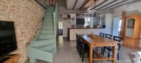 a kitchen and dining room with a table and a staircase at Meublé de tourisme &quot;Les brosses tillots&quot; in Mary