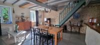 a dining room with a wooden table and chairs at Meublé de tourisme &quot;Les brosses tillots&quot; in Mary