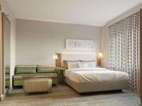 Un dormitorio con una cama grande y un sofá. en Home2 Suites By Hilton New York Times Square, en Nueva York