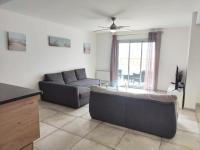 a living room with a couch and a table at Maison de 2 chambres avec vue sur la mer jardin clos et wifi a Sete in Sète