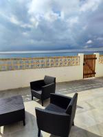 a patio with chairs and tables and the ocean at Maison de 2 chambres avec vue sur la mer jardin clos et wifi a Sete in Sète