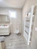 a white bathroom with a sink and a toilet at Maison de 2 chambres avec vue sur la mer jardin clos et wifi a Sete in Sète