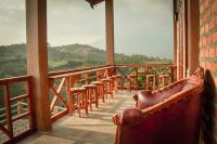 a balcony with a row of stools on a building at The Hills Kerinci in Kayu Aro