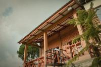 a house with a staircase in front of it at The Hills Kerinci in Kayu Aro