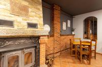 einen Kamin im Esszimmer mit einem Tisch und Stühlen in der Unterkunft Hotel Rural Rio Viejo in Cubillas de Arbas