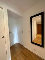 a room with a mirror on the wall and a hallway at Chaleureux T4, à 20 min de Paris in Argenteuil