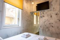 a room with a table and a window and a mirror at Timeout Heritage Hotel Zagreb in Zagreb