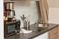 a kitchen counter with a microwave and a sink at Le Nature, un joli F2 au cœur de Rouen Rive Droite in Rouen