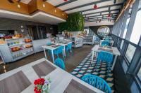 an empty restaurant with tables and blue chairs at Hotel Roseliere Bucaramanga in Bucaramanga