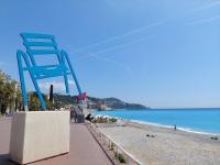 a giant blue chair sitting on the beach at studio à 2 mn à pied de la plage in Nice