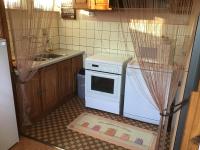 a kitchen with a white stove and a sink at Maison individuelle dans les Vosges du nord in Niederbronn-les-Bains