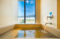 a bath tub filled with water in front of a window at E-DA Royal Hotel in Dashu