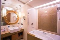 a bathroom with a sink and a tub and a mirror at E-DA Royal Hotel in Dashu