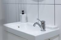 a white bathroom sink with a chrome faucet at Appartement entier au coeur de Nogent Sur Marne in Nogent-sur-Marne