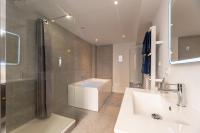 a bathroom with a sink and a shower and a tub at Le Lovely cosy jacuzzi centre-ville wifi in Rouen